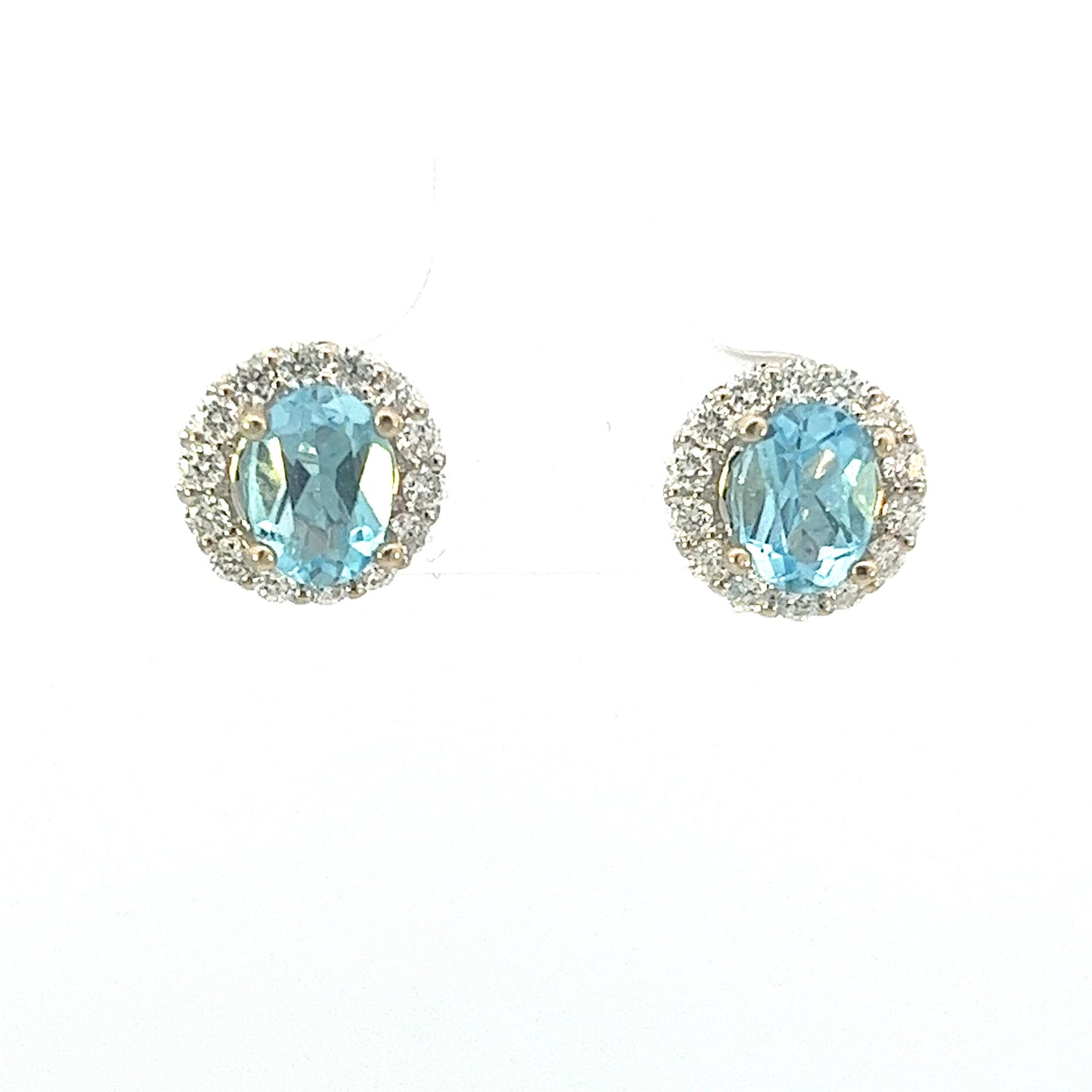 18k white gold 1.5ct total weight oval blue topaz and diamond earrings